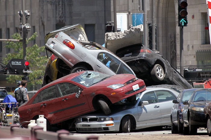 Workers stage a car accident on the Michigan Avenue during the filming of the movie <i>Transformers 3</i> on July 16, 2010 in Chicago, Illinois. Sections of Michigan Avenue, in the heart of the city's downtown, were closed until Monday morning to accommodate the filmmakers. (Photo: AFP)