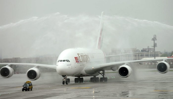 An Emirates A380 Airbus - the world's largest passenger aircraft is given a water cannon salute as it taxis after touchdown at terminal T-3 of Indira Gandhi International Airport in New Delhi on July 15, 2010. The Emirates flight EK 516 was the first commercial A380 flight to land at the new terminal a day after it was inaugurated -- a shiny glass-and-steel symbol of the country's aspirations as an emerging global power. The state-of-the-art hub, which cost nearly three billion dollars and can handle 34 million passengers a year, was showcased at a special ceremony by Prime Minister Manmohan Singh ahead of its mid-July public opening. The airport which can handle 34 million passengers a year was built in a record 37 months, officials said. (Photo: AFP)