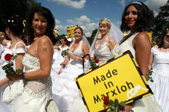 Women wearing wedding dresses take part in the "Still Life" Ruhr 2010 European Capital of Culture festivities with the initiative "100 brides for Marxloh" on the Autobahn A40 near Essen, western Germany on July 18, 2010, to represent Duisburg's grubby district Marxloh as the "most romantic street in Europe", as the neighbourhood offers more than 50 bridal fashion stores. Some 20,000 picnic tables were lined up end-to-end after the 60-kilometre-long stretch of one of Europe's busiest motorways was cleared of its usual traffic, between the cities of Dortmund and Duisburg, and became a stream of pedestrians and cyclists. The event is a highlight in the Ruhr 2010 European Capital of Culture festivities, which has seen Germany's rust belt region transformed into a hotbed of the arts with hundreds of concerts, plays and exhibitions planned throughout the year. (Photo: AFP)