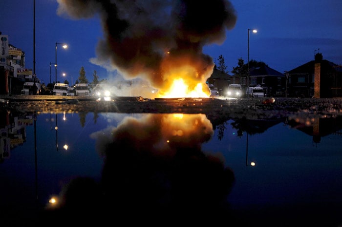 Cars burn during Nationalist rioting in the Ardoyne area of North Belfast, Northern Ireland on July 12, 2010. Rioting by Catholics left 27 police injured in Northern Ireland, including three with gunshot wounds, officials said on Monday, ahead of the biggest day of Northern Ireland's marching season. (Photo: AFP)