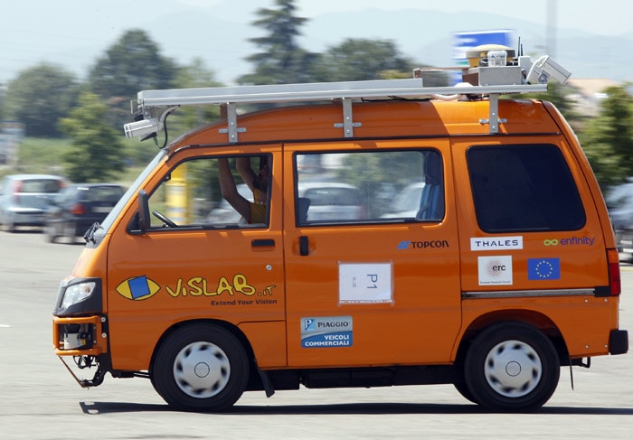 In this Thursday, July 15, 2010 photograph a technician works in an unmanned electric-powered vehicle as it makes its way in a street of Parma, Italy. Next week, four electric-powered orange vans depart on what has been conceived as the longest-ever test drive of unmanned vehicles: a 13,000-kilometer, three-month road trip from Italy to China. The vehicles, equipped with four laser scanners and seven video cameras that work in concert to detect and help avoid obstacles, will brave the traffic of Moscow, the intense summer heat of Siberia and the bitter cold of the Gobi desert before the planned arrival in Shanghai at the end of October. (Photo: AP)