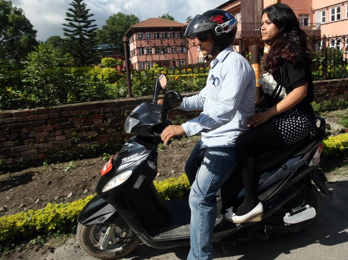 Nepalese woman Nihita Biswas, 21, who reportedly married "Bikini Killer" Charles Sobhraj in prison two years ago, leaves the Supreme Court on the back of a scooter in Kathmandu on July 14, 2010. Nepal's Supreme Court on July 14 deferred its ruling on a murder conviction appeal by "Bikini Killer" Charles Sobhraj, the Frenchman linked to a series of backpacker killings in Asia in the 1970s. The two-judge bench, which was due to announce a decision on Wednesday, said it had not had enough time to study corroborating documents submitted during the latter stages of the appeal process. (Photo: AFP)