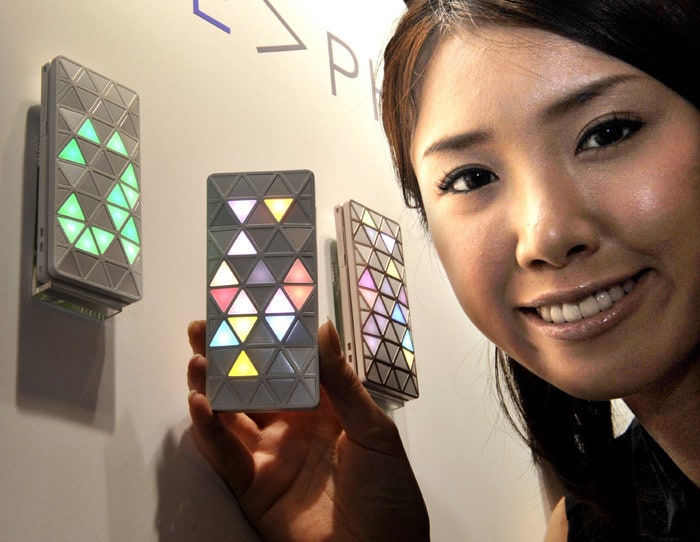 Japan's second largest mobile communication operator KDDI unveils the stylish mobile phone, flashing triangular patterned colorful LED lights "Light POOL", designed by Japanese industrial designer Hironao Tsuboi in Tokyo on July 13, 2010. KDDI will put it on the market in this month as a part of the design conscious mobile phone project "Iiida". (Photo: AFP)