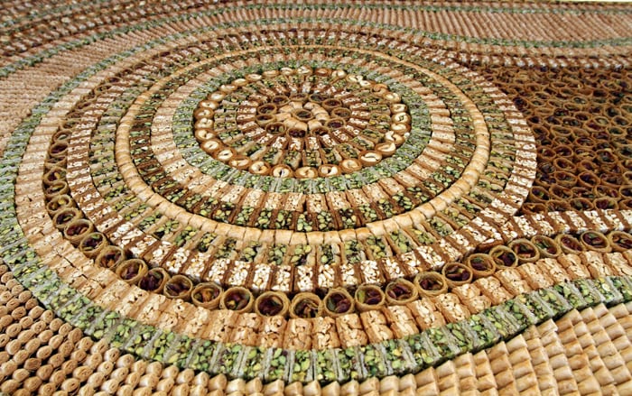 Picture shows part of a mosaic of traditional Arabic sweets, measuring 112 meters long, which entered the Guiness Book of World Records as the biggest of its kind on July 14, 2010 in Damascus. (Photo: AFP)