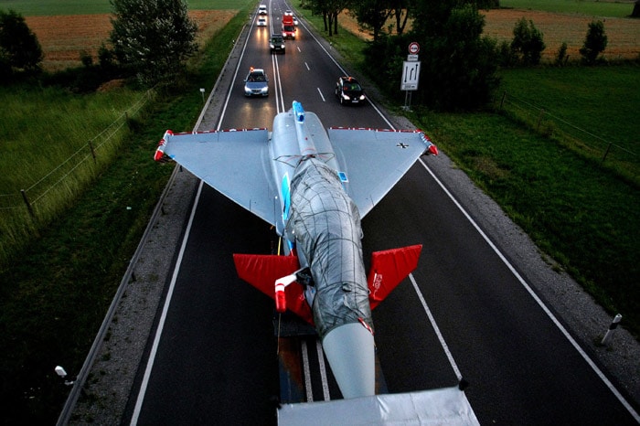 A 70 million euro worth Eurofighter of the German Bundeswehr is carried on an articulated lorry near Buchloe, southern Germany on July 12, 2010. For several years, the high tech airplane was used as a learning object by the air force school in Kaufbeuren, southern Germany. After having been dismantled and assembled several times, it will now face an overhaul by European aerospace corporation EADS (European Aeronautic Defence and Space Company) in the Military Air Systems branch in Manching. (Photo: AFP)