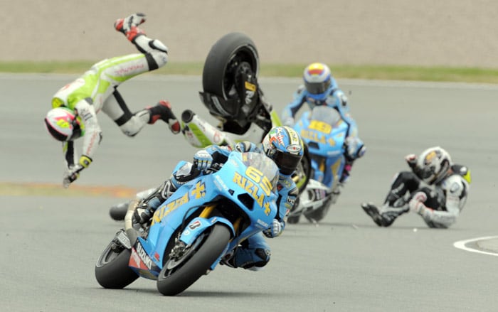 Ducati rider Aleix Espargaro from Spain, left, loses control as he passes by crashed Honda rider Randy de Puniet, right, from France during the Moto GP race of the Grand Prix of Germany at the Sachsenring circuit in the village of Hohenstein-Ernstthal, near the city of Chemnitz, Germany, on Sunday, July 18, 2010. (Photo: AP)