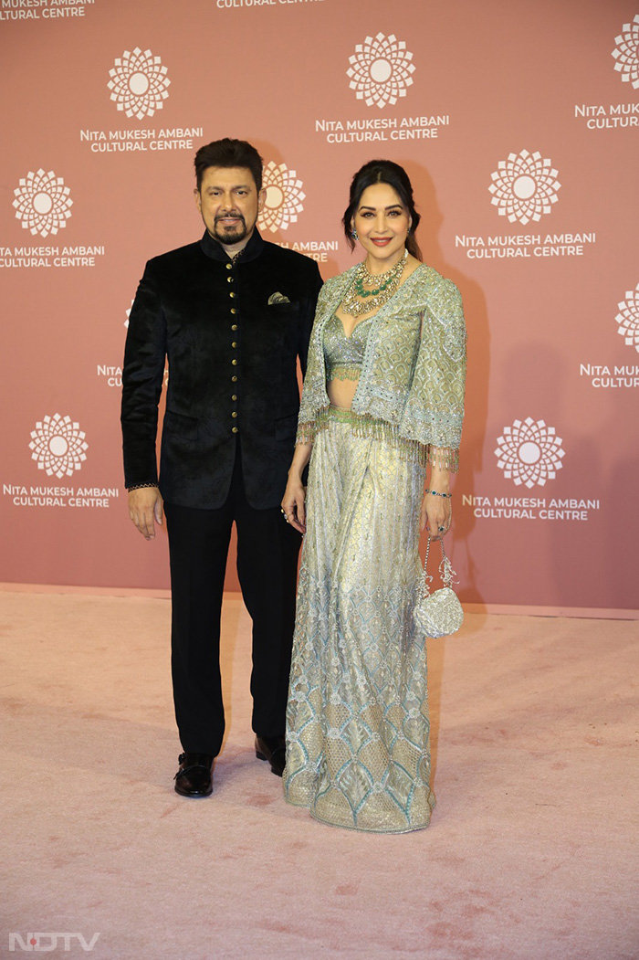 Madhuri Dixit looked mesmerizing a silver gown as she attended the event in Mumbai with husband Shriram Nene. (Image Courtesy: Varinder Chawla)