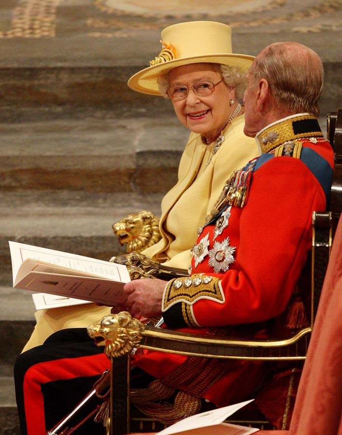 Queen Elizabeth II speaks with Prince Philip at Westminster Abbey.  Reports say the Queen will take a post-wedding weekend for herself, away from Buckingham Palace.