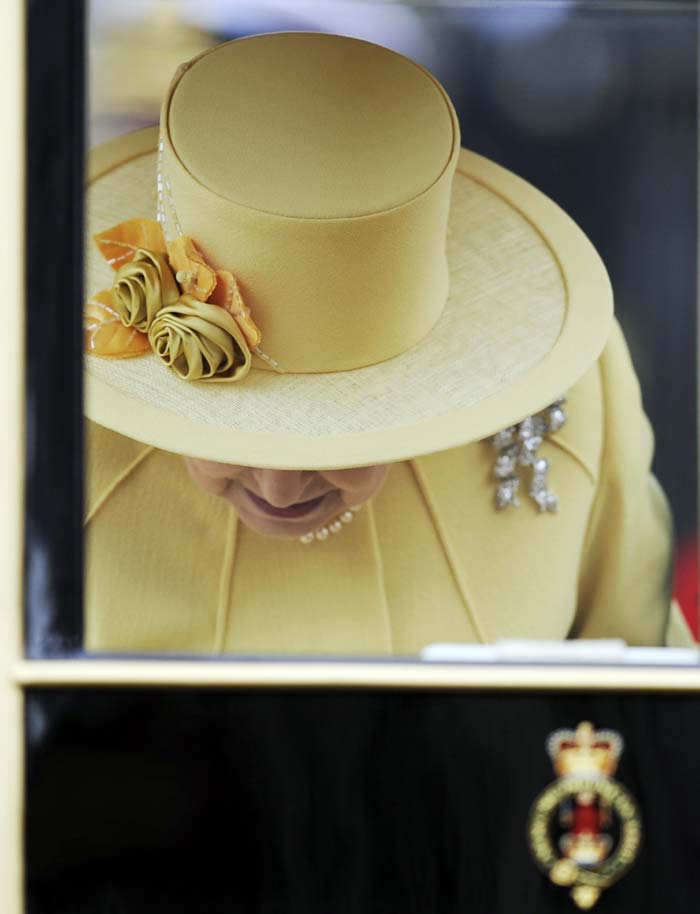 Queen Elizabeth chose a yellow dress, overcoat and hat, all by Angela Kelly.