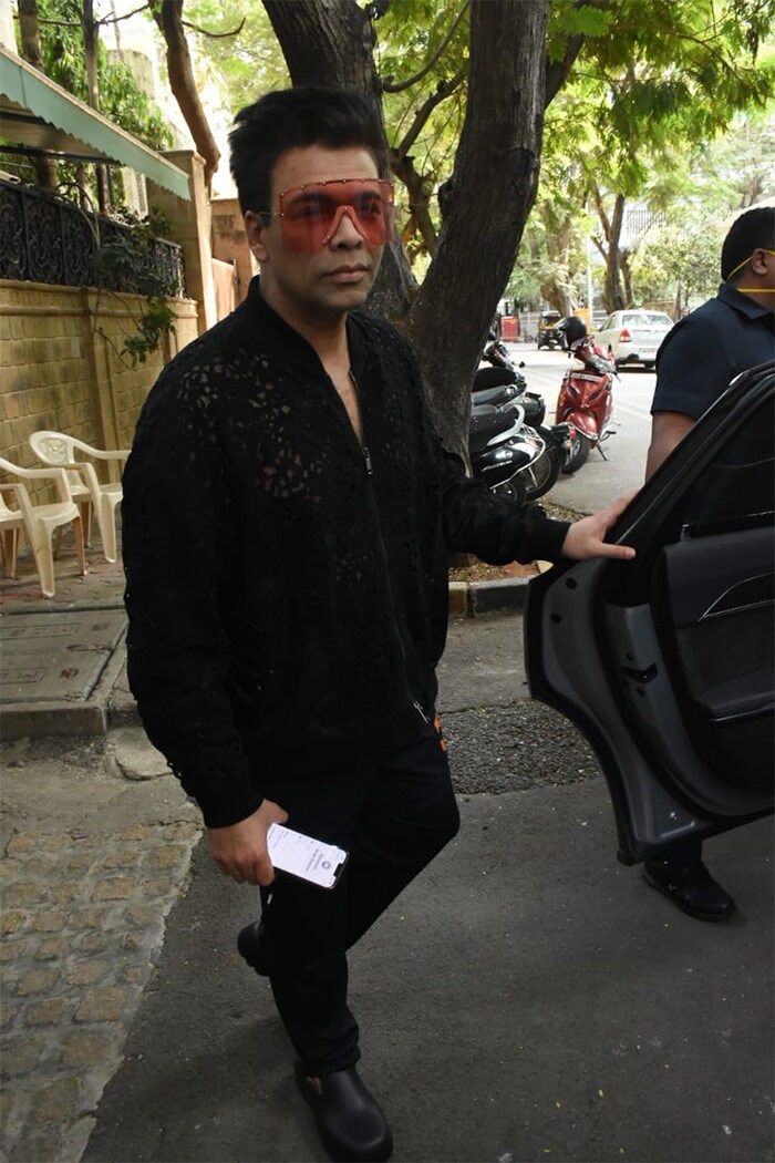 Looking dapper in black, Karan Johar was clicked outside Anil Kapoor's house