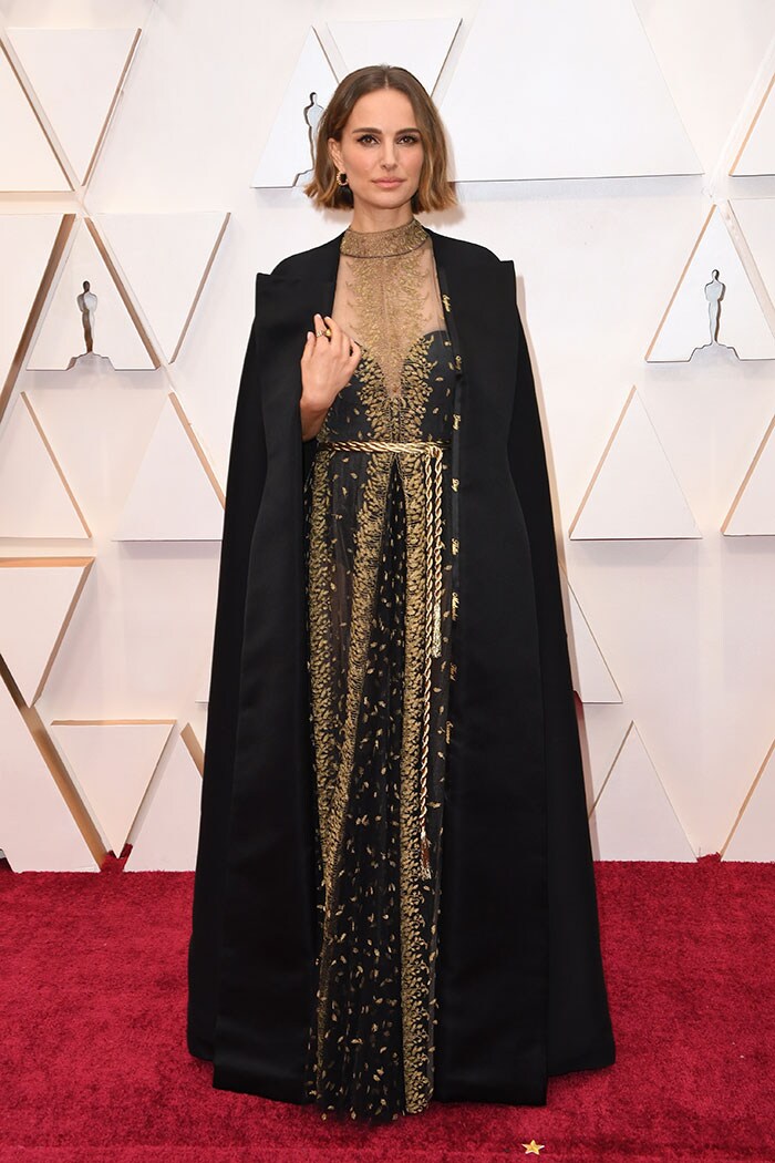 Natalie Portman wore a black and golden Dior Haute Couture dress, the cape of which had the names of this year's snubbed female directors, and Cartier jewels.