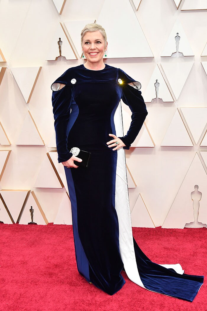 Olivia Colman wore a velvet Stella McCartney gown with a cape.