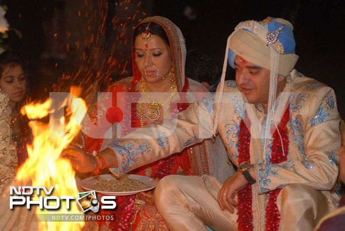 The bride and groom perform the puja.