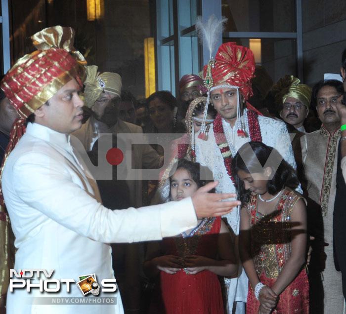 Riteish leads the way as his new bride follows.