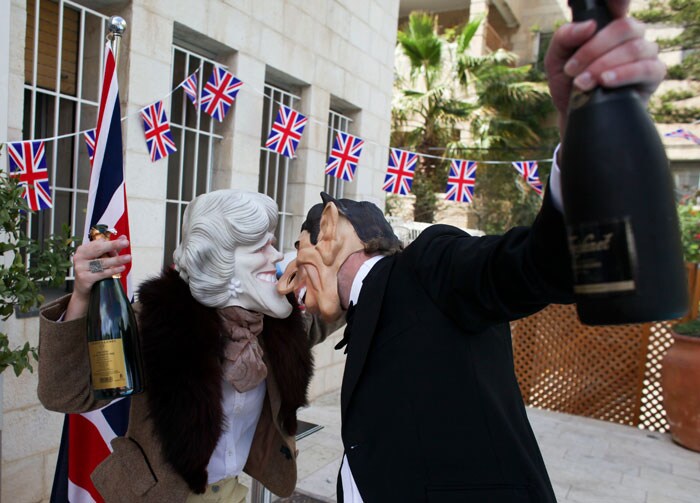 In Jerusalem, guests dress as Prince Charles and Camilla, Duchess of Cornwall while attending a costume party to celebrate the Royal Wedding.