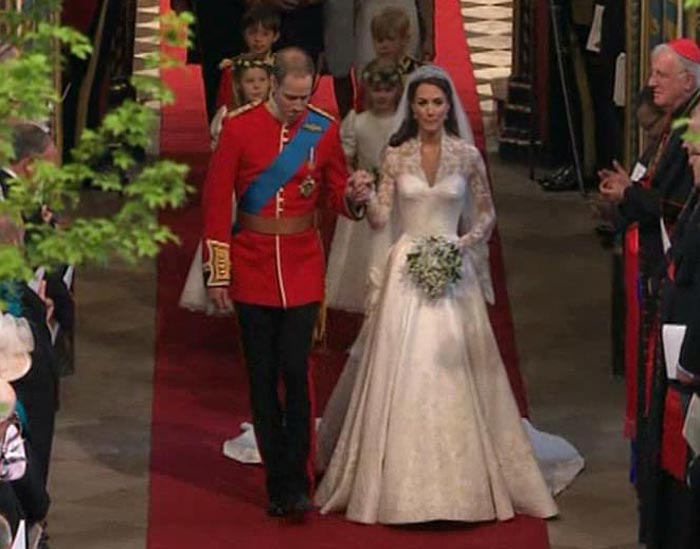 The new Duke and Duchess of Cambridge walk down the aisle from the altar of Westminster Abbey to outside, where their carriage waits.