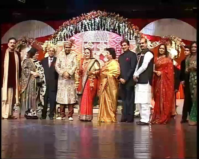 The bride and groom are busy posing with the string of dignitaries lining up to greet them.