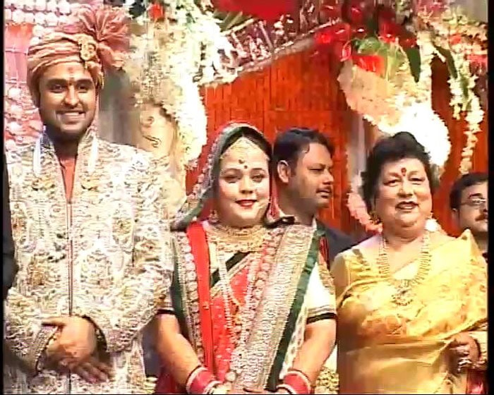 Bride Sivanka and groom Karan pose for the camera.