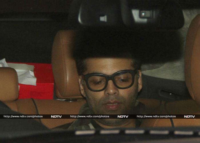 Filmmaker Karan Johar was too busy on his gadget to smile for the camera persons.