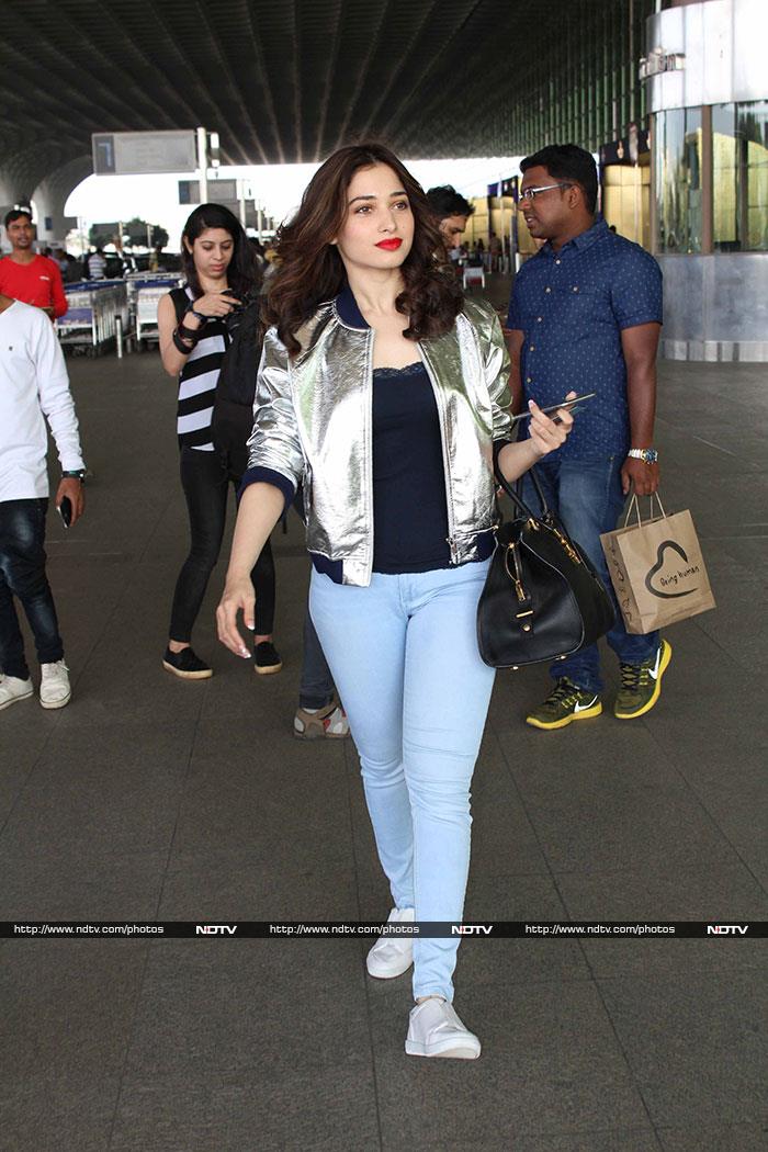 <I>Baahubali</i> actress Tamannaah Bhatia lit up the airport in a metallic hued jacket, black top and pants.