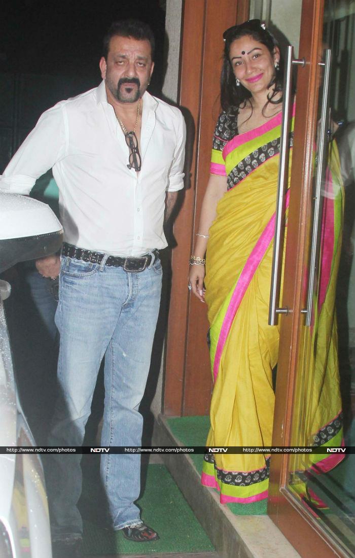 Sanjay and Maanyata Dutt were spotted in Mumbai on Monday, looking rather stylish - he in white shirt and jeans, she in a cheery yellow <i>sari</i> with multi-colour borders.