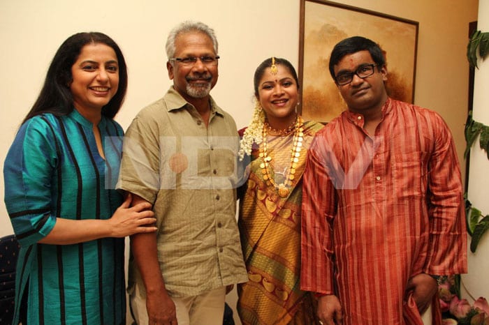 Director Mani Ratnam and wife Suhasini smile for the cameras as they pose with the couple.