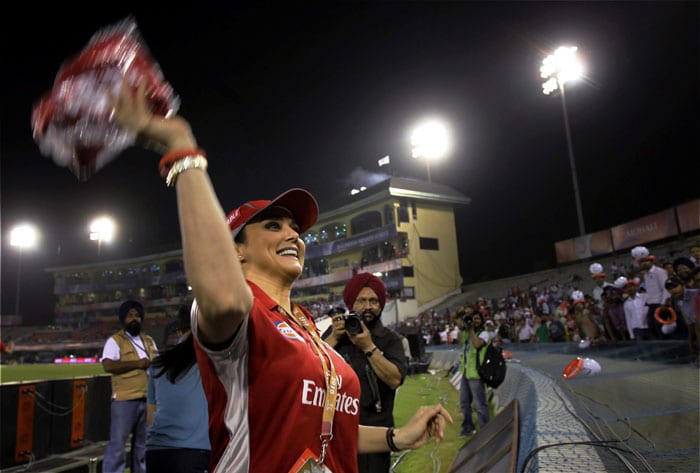 Co-owner of Kings XI Punjab Preity Zinta throws free shirts to fans of the team before the start of the Indian Premier League 3 match against Rajasthan Royals in Mohali. (PTI Photo)