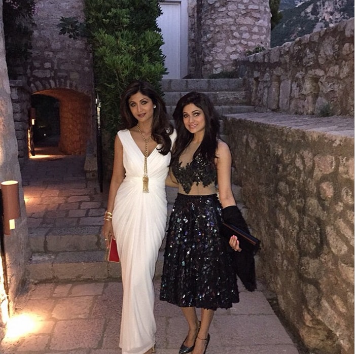 Shilpa looked uber-glamorous in a white gown by Zulekha J Shariff which she wore with a gold necklace and red notebook clutch. Her sister Shamita looked as pretty as Shilpa in embellished separates by Rocky S. We like! <br><br>This image was posted on Instagram by <a href=" https://instagram.com/officialshilpashetty/" target="_blank" rel="nofollow" >Shilpa Shetty</a>