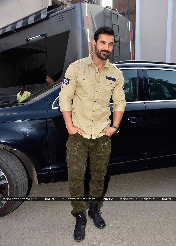 John looked handsome in a military green shirt and printed pants teamed with black boots.