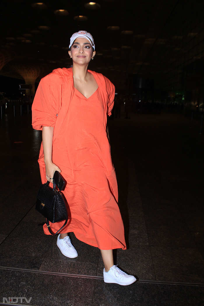 Orange is the new black - that's Sonam Kapoor's airport look for you. (Image courtesy: Varinder Chawla)