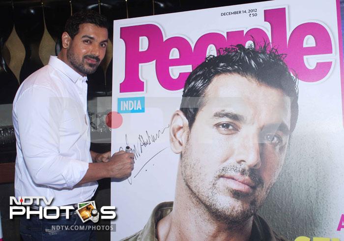 The actor, who is all set for the release of his next film <i>Race 2</i>, autographs the life-size poster of him.