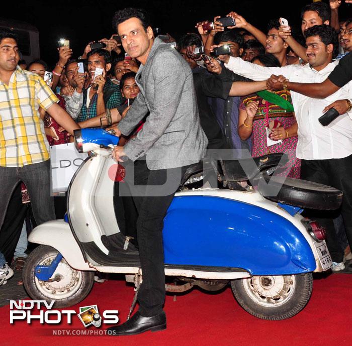 Manoj Bajpai, who plays a CBI officer in the movie, sits on a scooter.