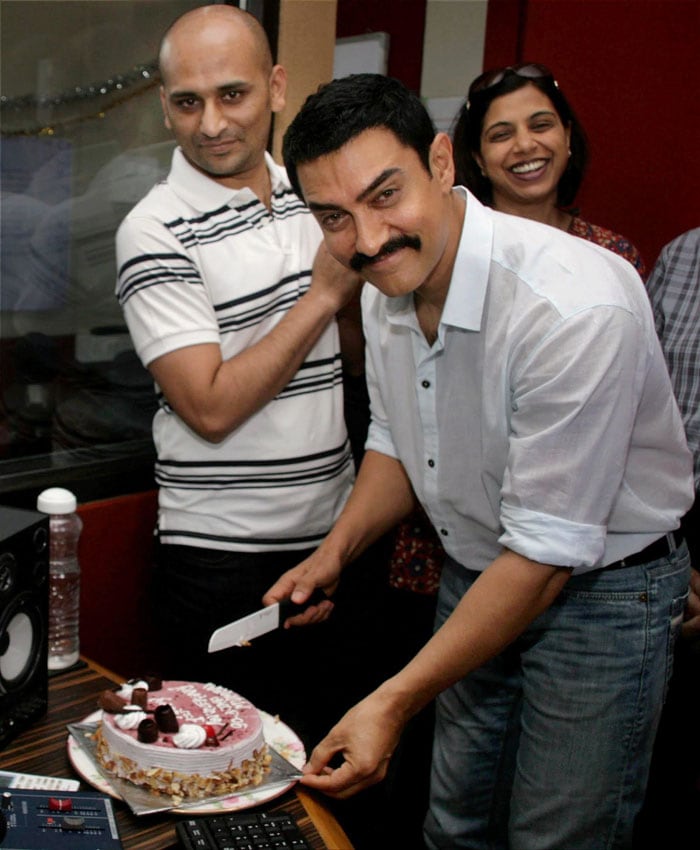 Aamir Khan cuts cake at the event. (Photo: PTI)