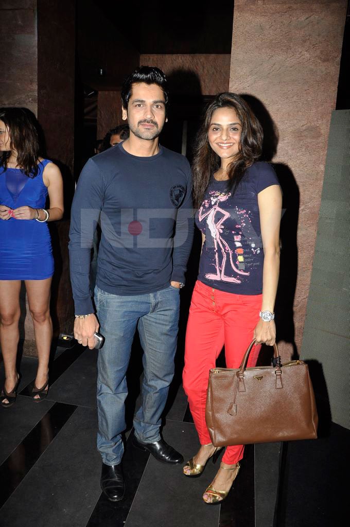 Madhoo makes a style statement in those red pants. Seen here with Manoj Bajwa.