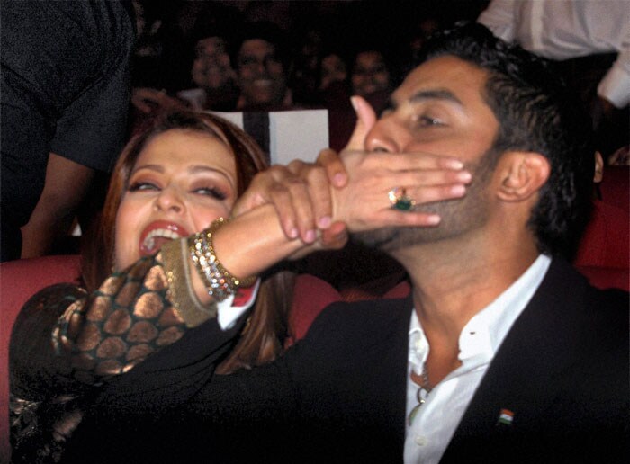 Abhishek Bachchan and his wife Aishwarya Rai Bachchan share a light moment during a prize distribution function of 'Aanadalok' a film magazine, in Kolkata.