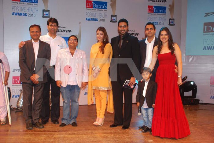 The power couple pose with the man of the moment, Dr Batra, and other guests.