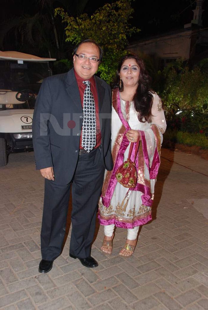 A checkered Rakesh Bedi enters with his wife.