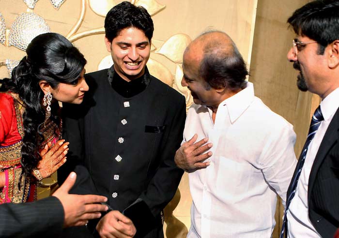 Actor Rajanikanth interacts with former cricketer K Srikkanth?s son Adithya and his newly wedded wife Aishwarya at their wedding reception in Chennai on Wednesday. (Photo: PTI)