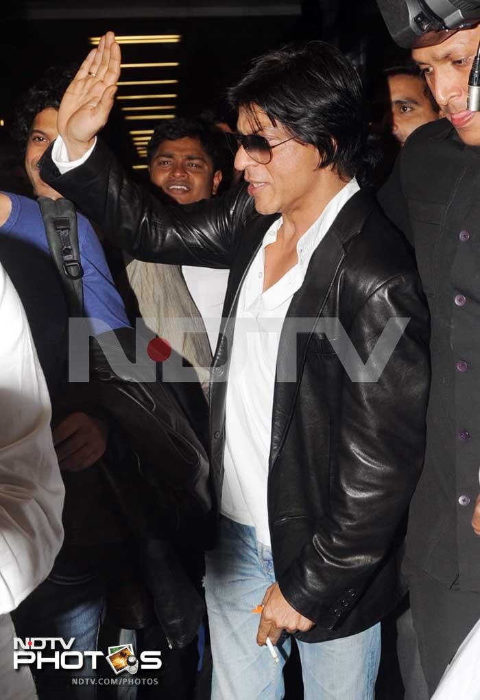 "Yay bak in mumbai...still. In plane though...somebody in our parking spot...uh huh ???!!!," SRK posted on Twitter.