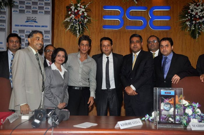 Shah Rukh poses for the camera with senior officials of Eros International.