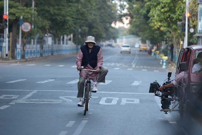 With Song in His Heart, Big B Cycles Through City of Joy