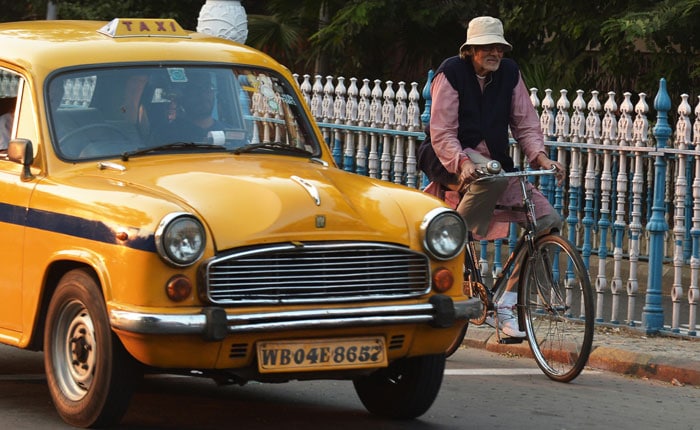 With Song in His Heart, Big B Cycles Through City of Joy