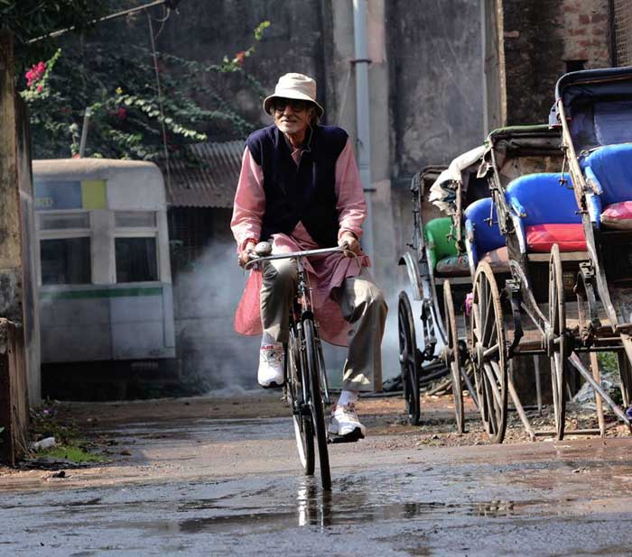 With Song in His Heart, Big B Cycles Through City of Joy