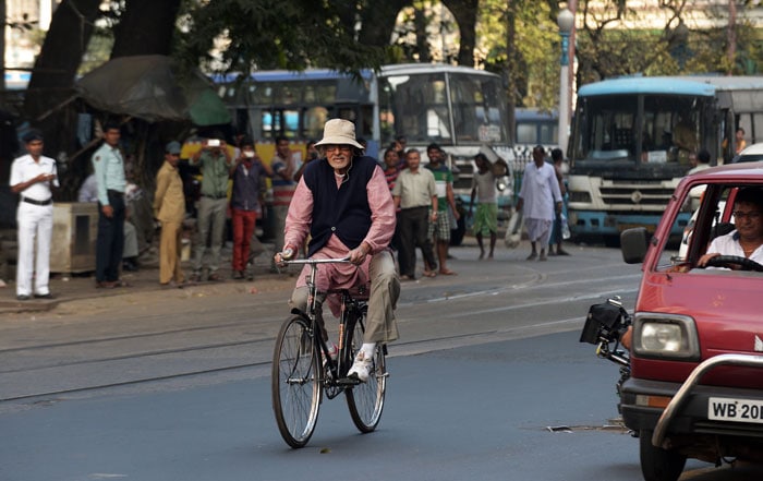 With Song in His Heart, Big B Cycles Through City of Joy