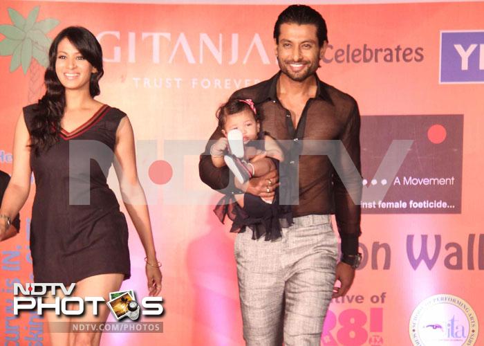 Actors Barkha Bisht and Indraneil Sengupta walk the ramp in style with their little daughter.