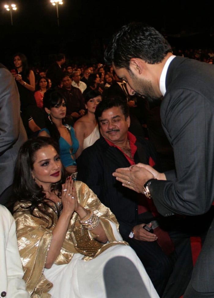 Abhishek Bachchan greets Rekha at the Stardust Awards as Shatrughan Sinha looks on. (Photo: AFP)