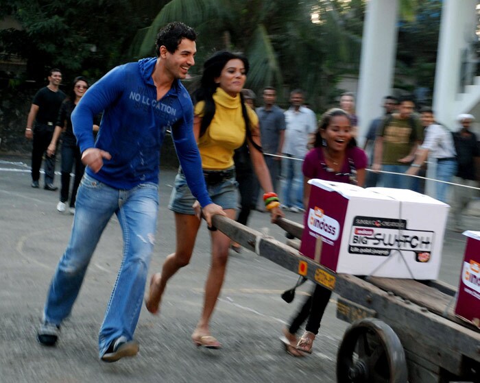 John Abraham takes part in a barrow race with contestants in a television show in Mumbai. (Photo: AFP)