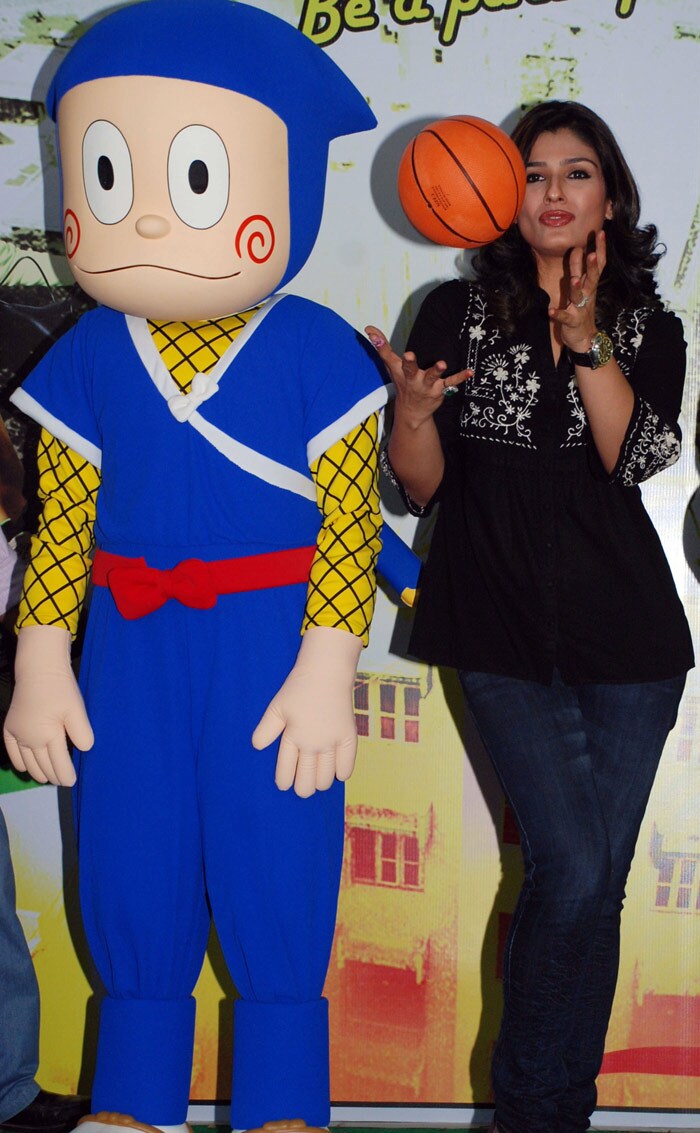 Raveena poses with a ball during a promotion ceremony. (Photo: AFP)