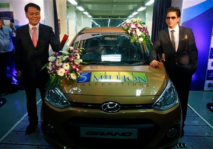 Bollywood superstar Shah Rukh Khan, who is Hyundai India's brand ambassador, posed for a picture with an i10 Grand, which will mark Hyundai's 5 millionth car in India, on Thursday, October 17, in Chennai.<br><br>

Also seen in the picture is Hyundai Motor India Ltd. Managing Director and CEO Bo Shin Seo.<br><br>

SRK looked dapper in formals.