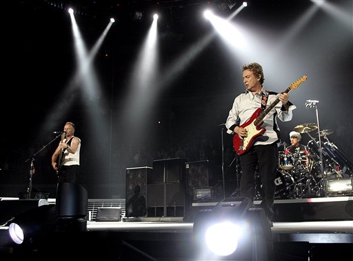 Guitarist Andy Sumers takes front stage with Sting, left, and drummer Stewart Copeland, right, as The Police begin their worldwide tour with a show in Vancouver.